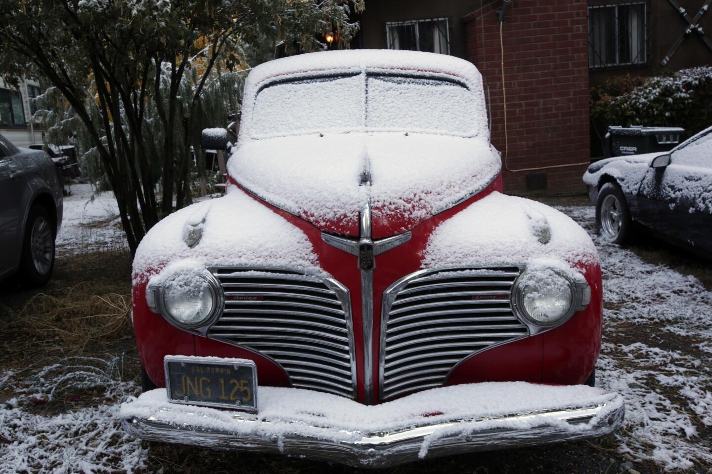 Cars parked at a home on Heath Creek Road are dusted in the season's first snowfall.