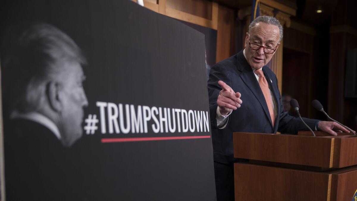 Senate Minority Leader Charles E. Schumer (D-N.Y.) discusses the government shutdown at a news conference hours after it took effect.
