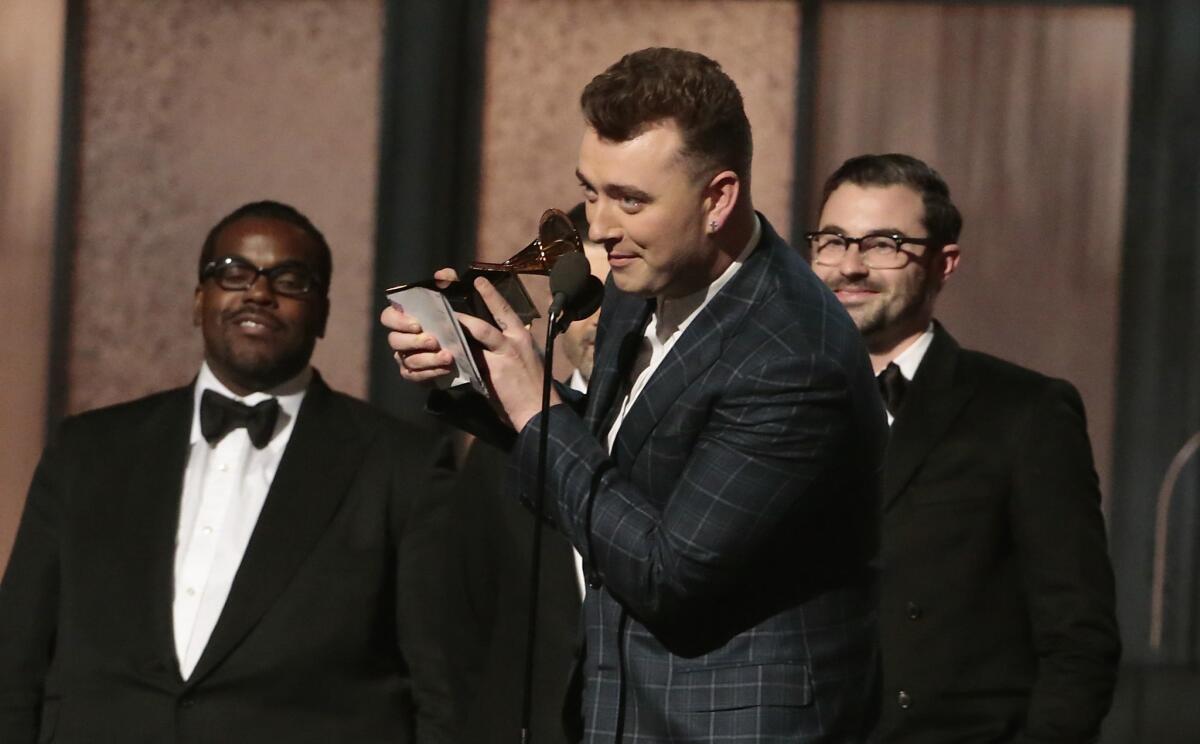 Sam Smith accepts the record of the year award for "Stay With Me." He won four major Grammys throughout the evening.