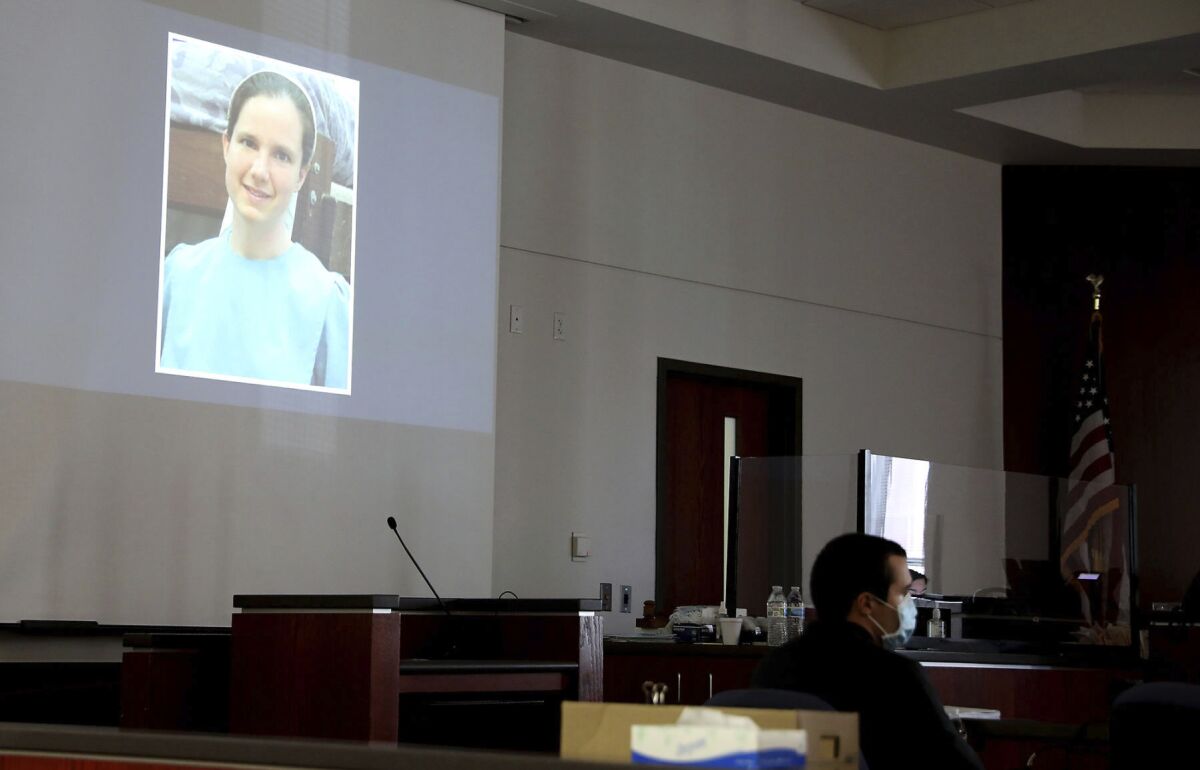 Mark Gooch, 22, sits below an image of Sasha Krause shown on a screen during his trial at the Coconino County Superior Court in Flagstaff, Ariz., on Friday, Sept. 24, 2021. Gooch is charged with first-degree murder in Krause's death in early 2020. (Jake Bacon/Arizona Daily Sun via AP)