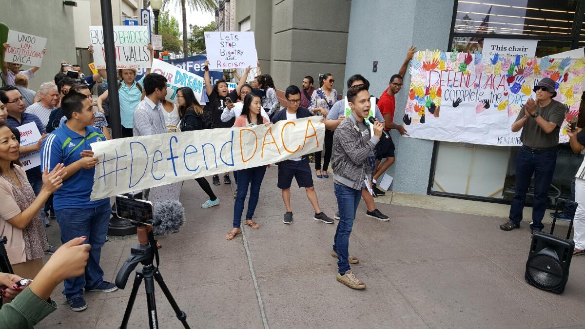 Luis F. Gómez, director of Immigration Resources, holds the mic 