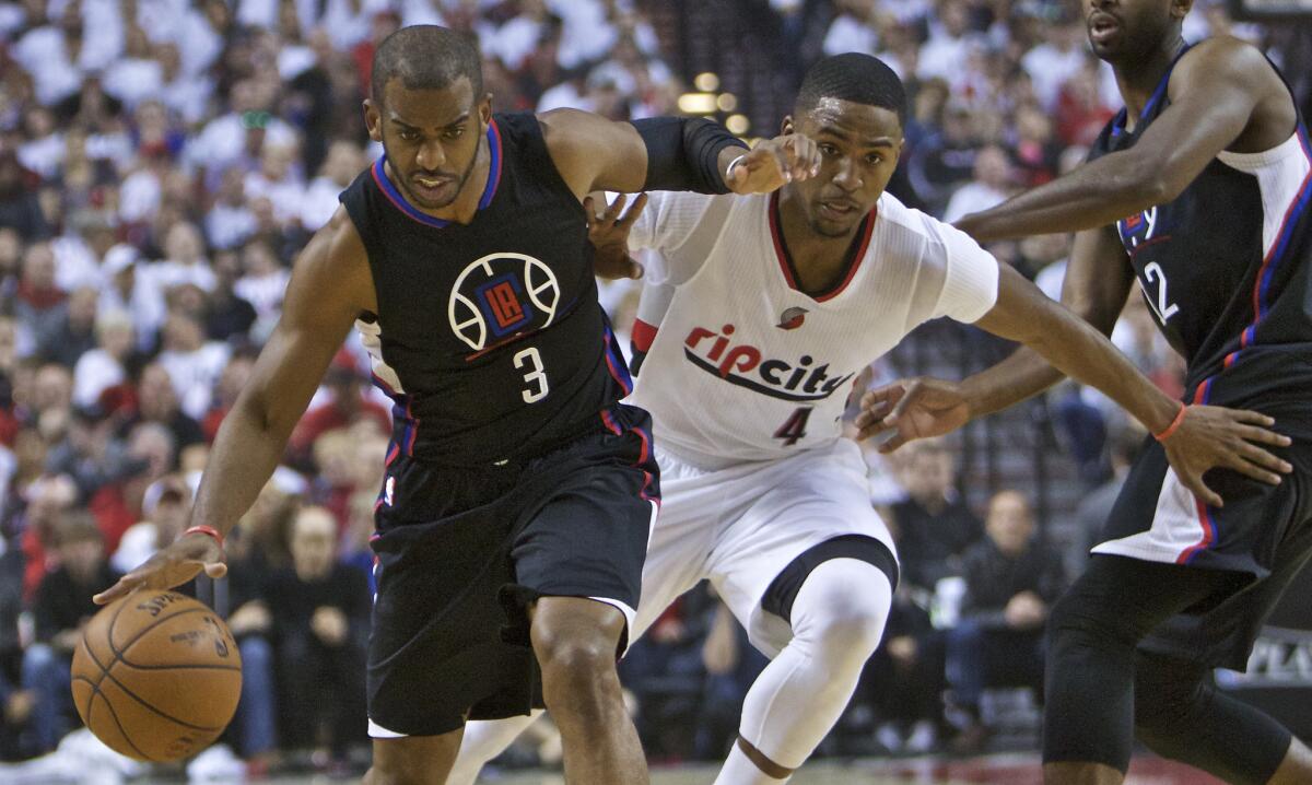 Clippers guard Chris Paul (3) dribbles past Trail Blazers forward Maurice Harkless (4) during the first half of Game 4.