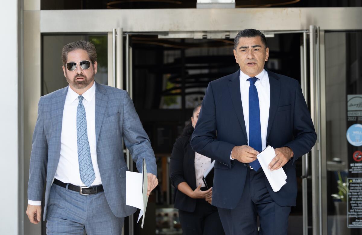 LAPD Assistant Chief Al Labrada, right, and his lawyer