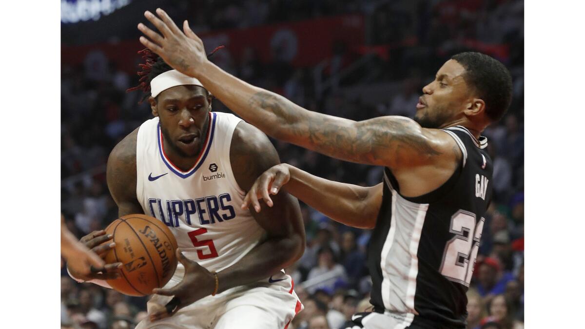 Clippers forward Monrezl Harrell bulls his way to the basket against Spurs forward Rudy Gay in the second quarter.