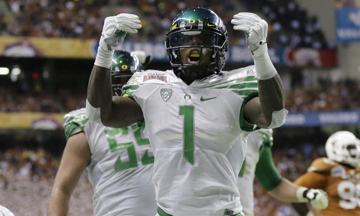 Oregon's Josh Huff celebrates after scoring a touchdown during the Ducks' 30-7 win over Texas in the Alamo Bowl on Monday.