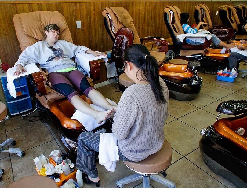 Julie Luu, right, gives a pedicure to Annie Backenstose at Sun Nails in Silver Lake. Of the 8,000 nail salons in California, about 75% are owned or operated by Vietnamese Americans, according to Nails magazine.