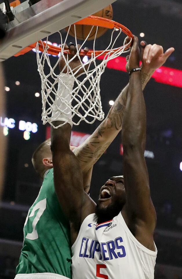 Clippers forward Montrezl Harrell hangs on the rim bfore being called for basket interference during the second quarter of a game Nov. 20 at Staples Center.