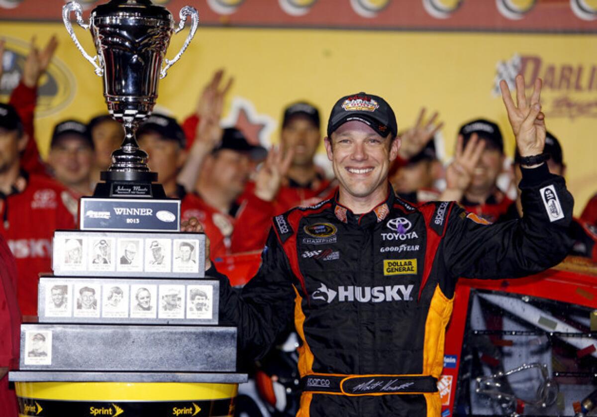 Matt Kenseth celebrates in Victory Lane and holds up three fingers to signify his third win this year.