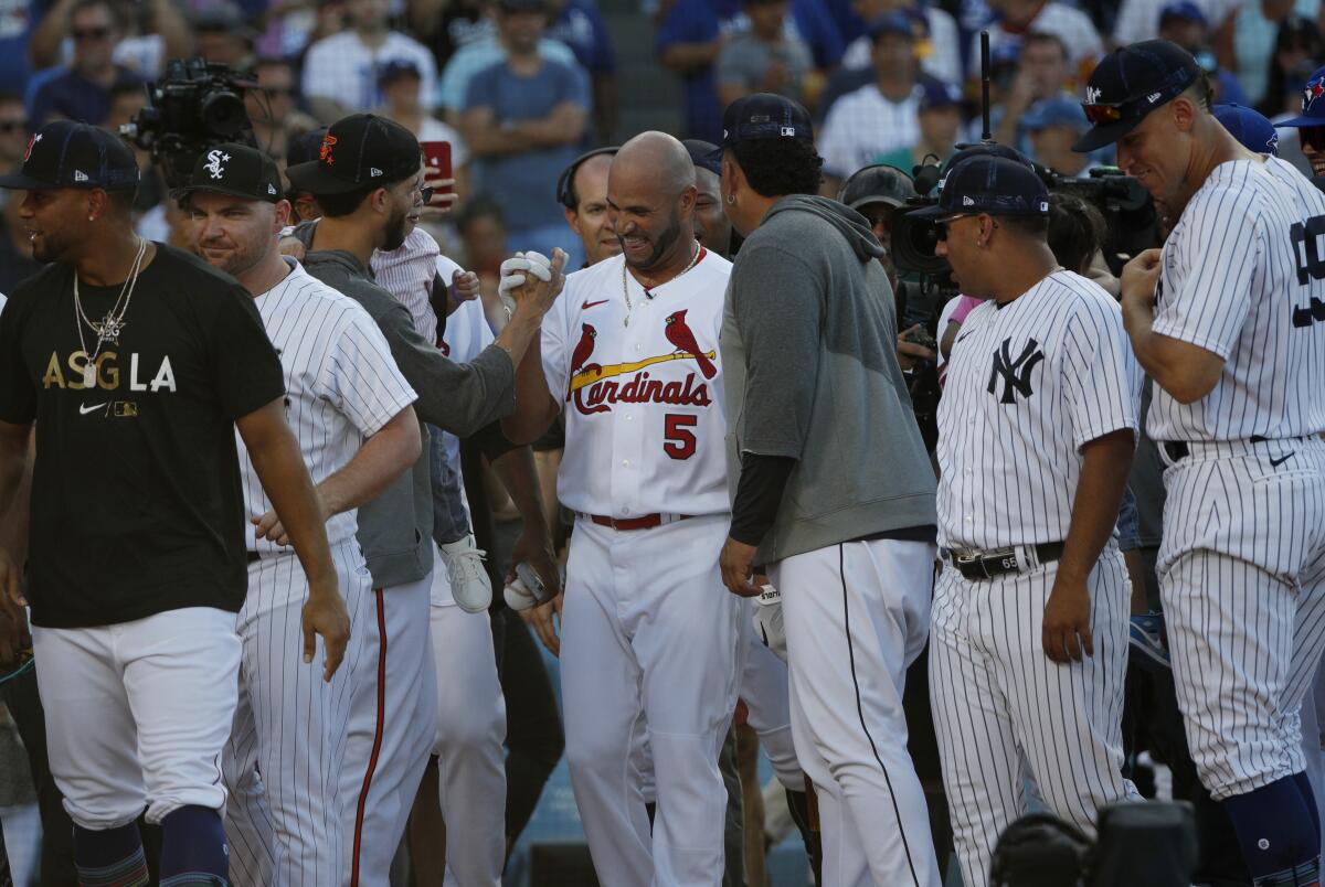 All- Stars from both teams pay tribute to St. Louis Cardinals' Albert Pujols during the home run derby at Dodger Stadium.