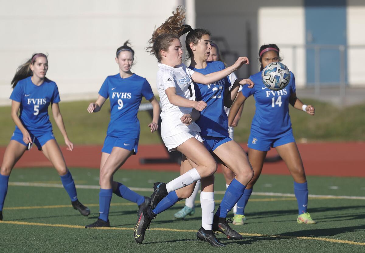 CdM's Ellie Rosing (19) battles to get into position for a shot as Fountain Valley's Karlee Giuntoli (22) defends.