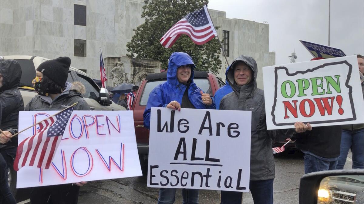 People protest Oregon Gov. Kate Brown's executive order shutting down much of the state's economy to stem the spread of the coronavirus, in an April rally outside the state Capitol.