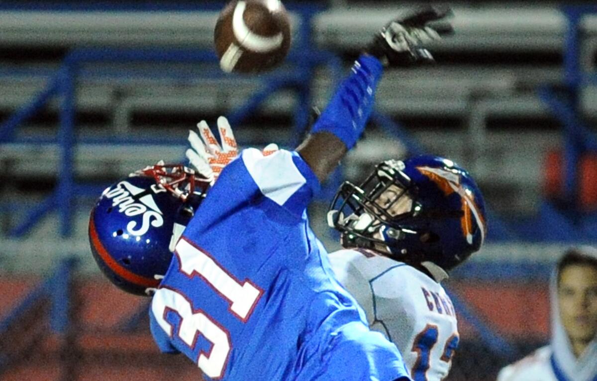 Westlake receiver Vincent Corso hauls in a touchdown pass in front of Serra's Max Williams in the first quarter of their Pac-5 Division playoff game on Friday night in Gardena.