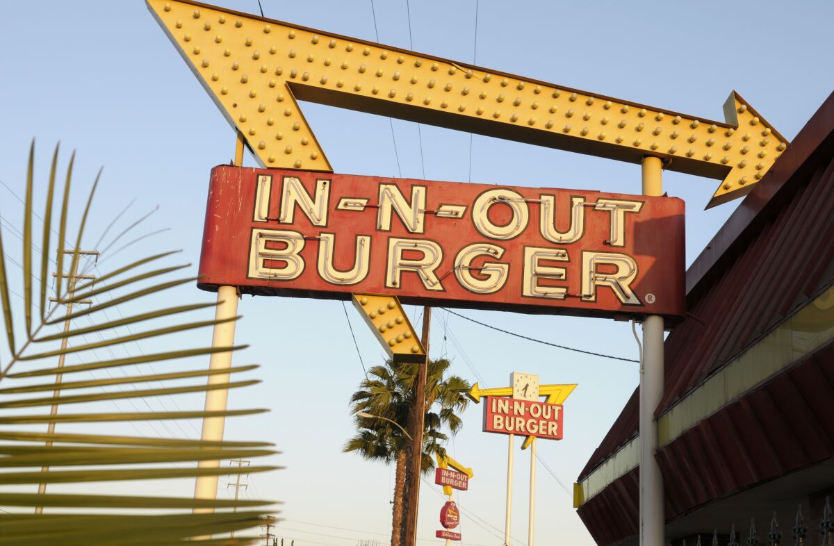 In-N-Out Burger signs fill the skyline on Tuesday, June 8, 2010, in Calif. The In-N-Out hamburger chain is sizzling mad after San Francisco shut down its indoor dining for refusing to check customers vaccination status. The company's Fishermans Wharf location  its only one in San Francisco  was temporarily shut by the Department of Public Health on Oct. 14. (AP Photo/Adam Lau)