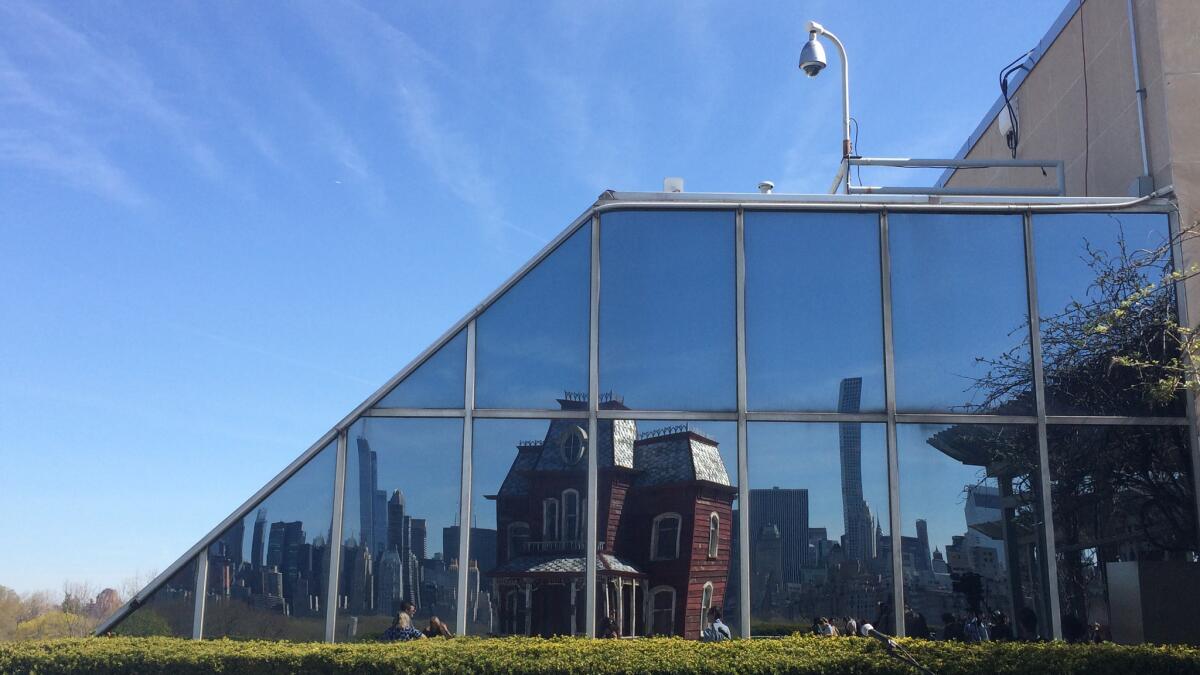 The artist's "PsychoBarn" reflected on glass.