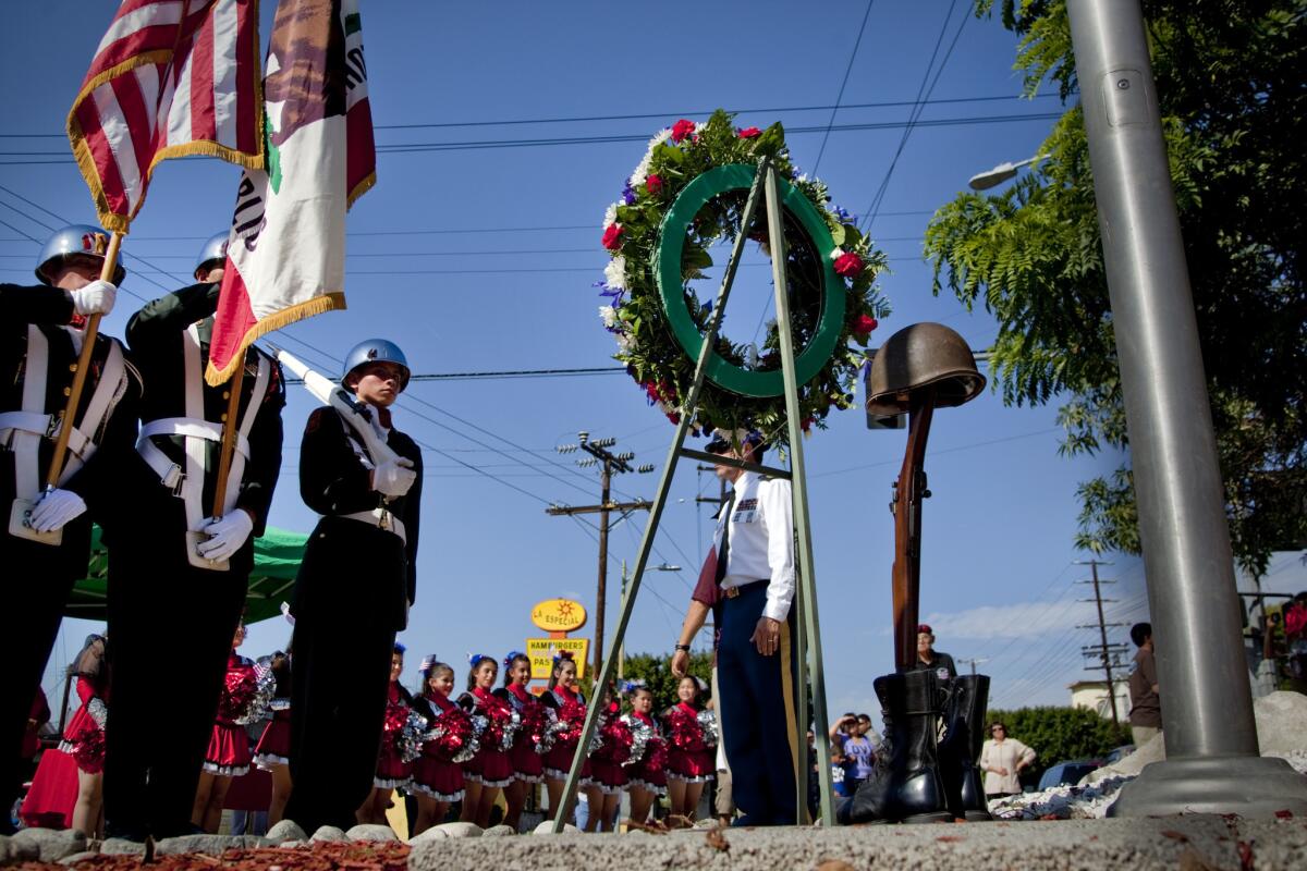 The Lincoln High School Honor Guard stands at attention after a wreath is placed at a Veteran's Memorial in Cypress Park.