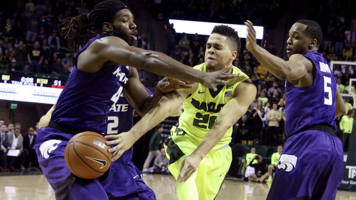 Baylor guard Manu Lecomte attempts to pass through the double-team defense of Kansas State forward D.J. Johnson, left, and guard Barry Brown during the second half Saturday.