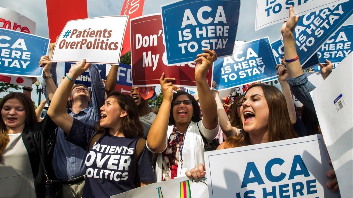 Supporters of the Affordable Care Act cheer after the Supreme Court ruled that Obamacare tax credits can go to residents of any state, outside the Supreme Court in Washington on June 25, 2015.