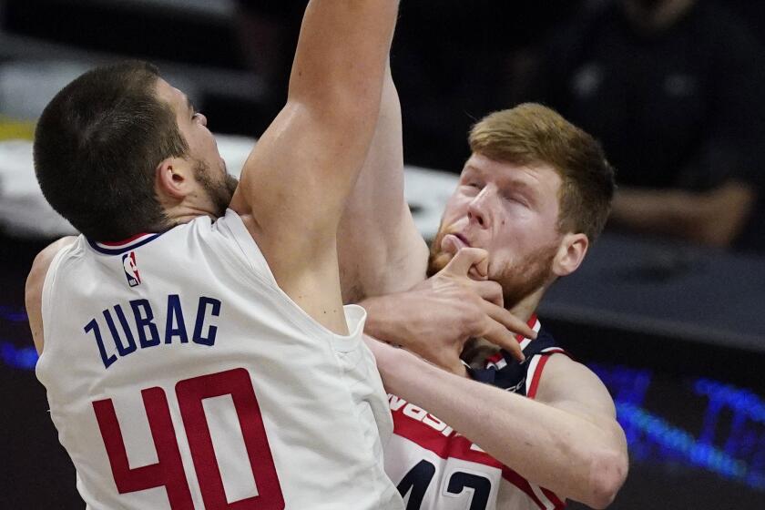 Clippers center Ivica Zubac shoots over Washington forward Davis Bertans on Feb. 23 at Staples Center.
