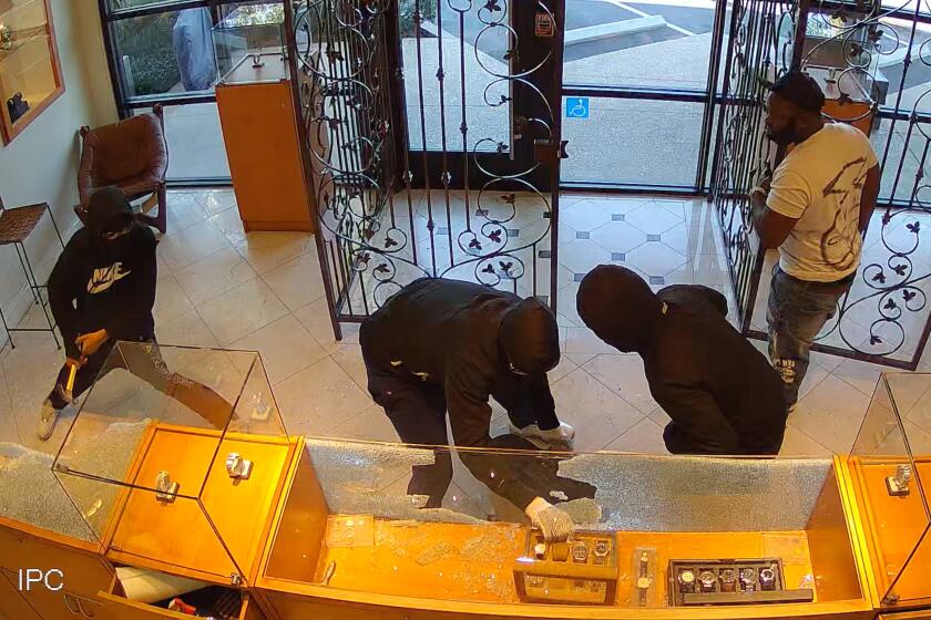 A screen grab shows the smash-and-grab robbery of $25,000 worth of watches that were stolen last week at a Newport Beach jeweler.