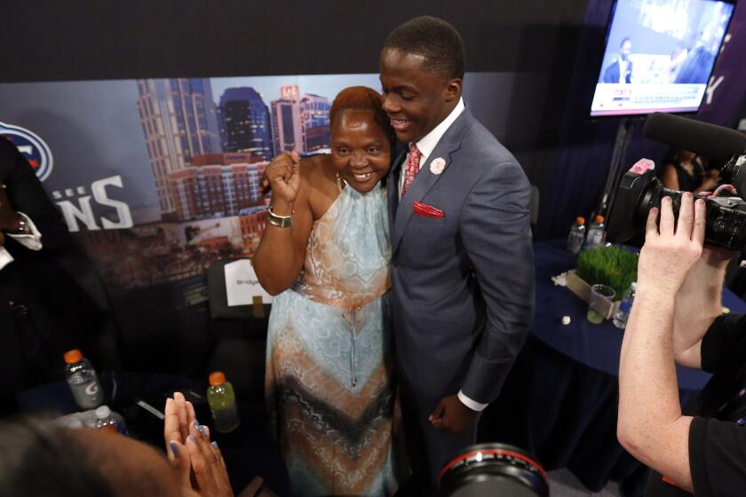 Former Louisville quarterback Teddy Bridgewater embraces his mother Rose Murphy after being selected 32nd overall by the Minnesota Vikings in Thursday's first round of the NFL draft at Radio City Music Hall.