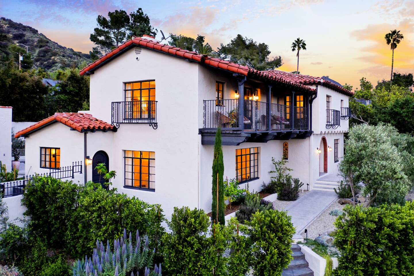 Listed for $2.685 million, the Spanish Revival-style home recently underwent a two-year renovation that introduced a host of modern updates while preserving certain period details. Features include redwood beams, arched doorways and a grand fireplace in the living room. Custom arched steel doors connect the indoor-outdoor living spaces. The 4,100-square-foot house has four bedrooms including two master suites. A La Cornue range with bronze accents steals the show in the kitchen.
