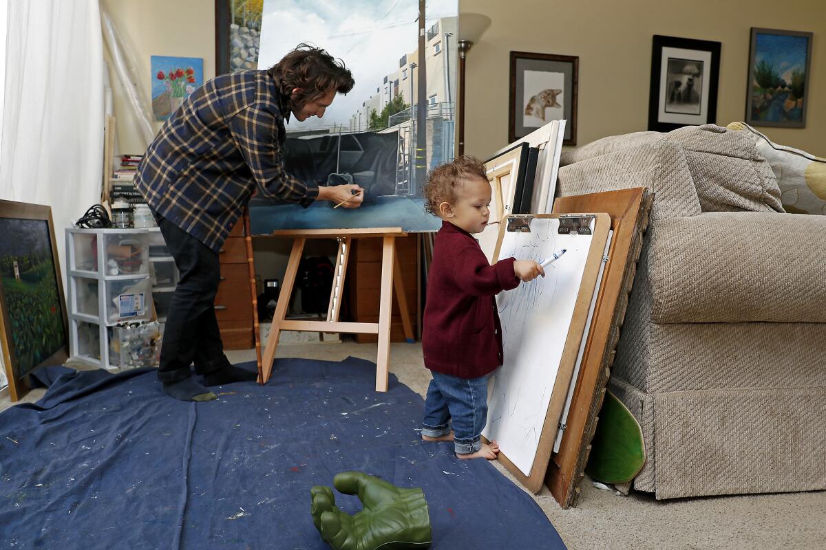 Artist Nico Sauceda and his 18-month-old son, Epic, create art at their home in Huntington Beach.