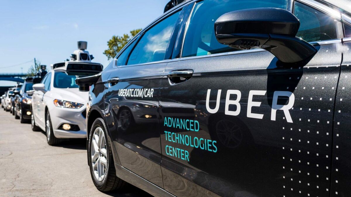 Pilot models of the Uber self-driving car are displayed in Pittsburgh in 2016.