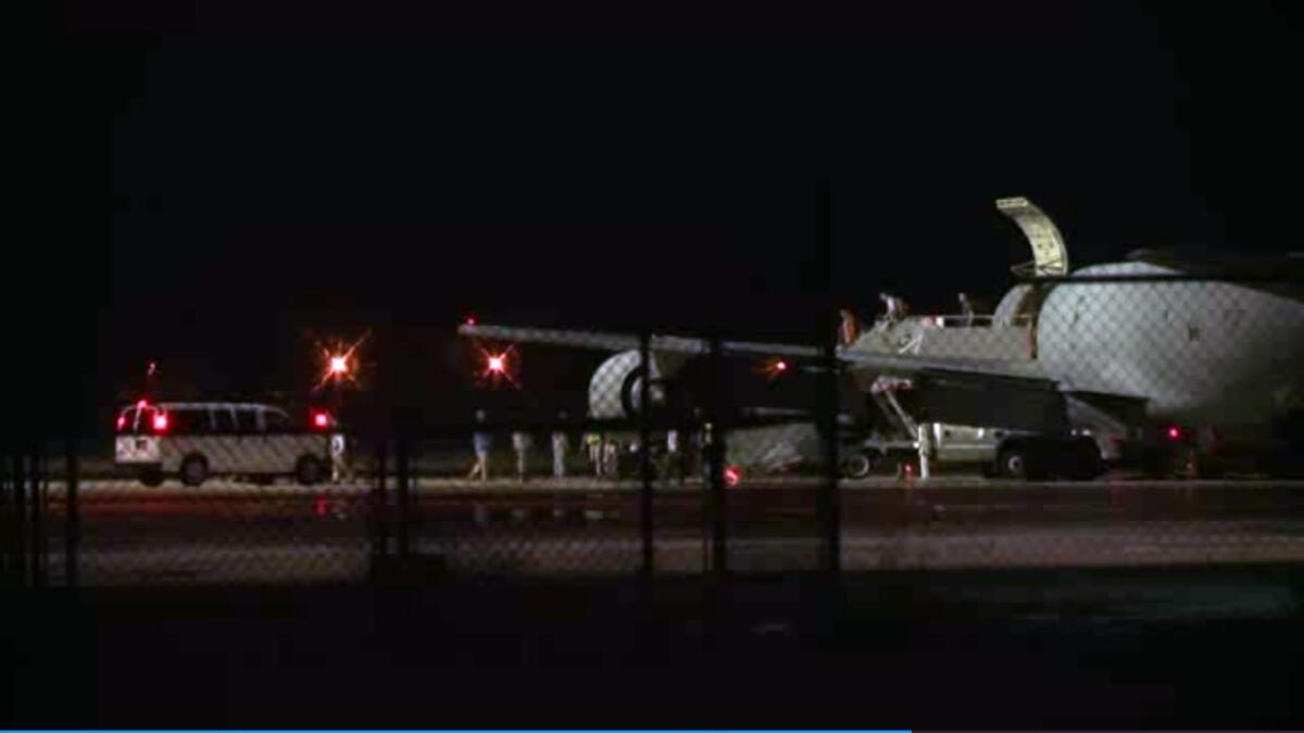 In this image from video, people on Sgt. Bowe Bergdahl's plane are greeted on arrival at Lackland Air Force Base in San Antonio.