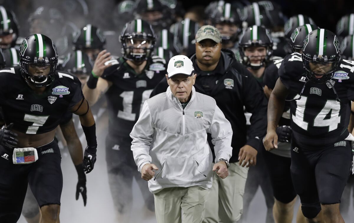FILE - Ohio head coach Frank Solich runs out onto the field with his team before the Mid-American Conference championship NCAA college football game against Western Michigan, in Detroit, Dec. 2, 2016. Former Nebraska coach Frank Solich will make his first public appearance at Memorial Stadium in 20 years when Nebraska honors him at its spring game on April 22, 2023. (AP Photo/Carlos Osorio, File)