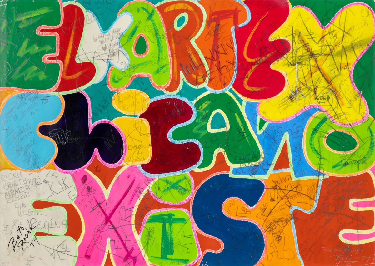 A graffiti-style painting features the phrase "El Arte Chicano Existe" in bright bubble letters.