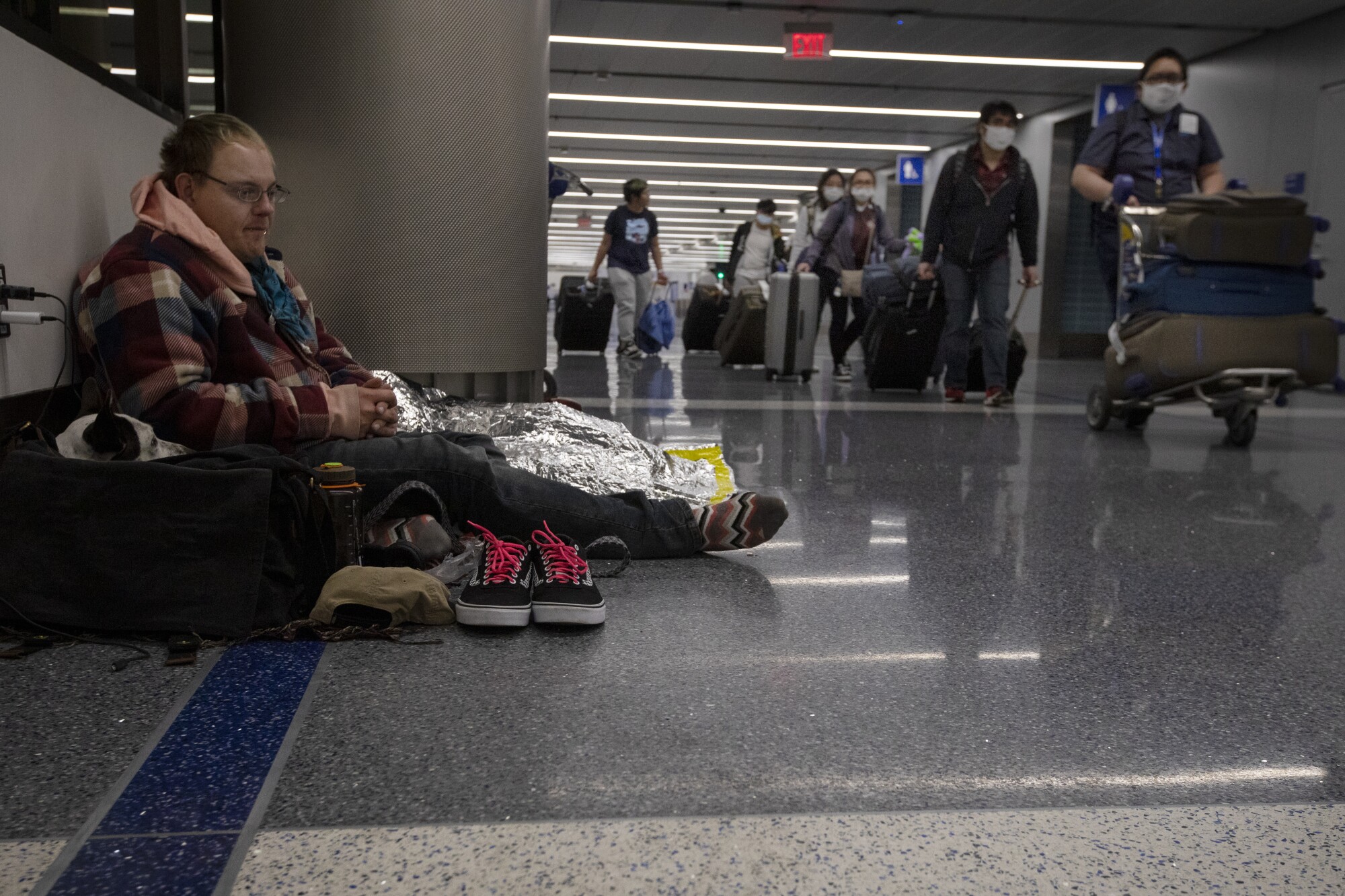 Seth Davis with his support dog, Poppy, at LAX, where they had been living since Christmas.