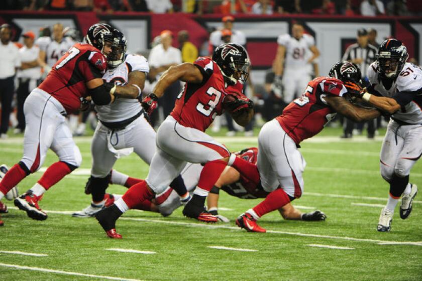 Michael Turner of the Atlanta Falcons carries the ball Monday night against the Denver Broncos.
