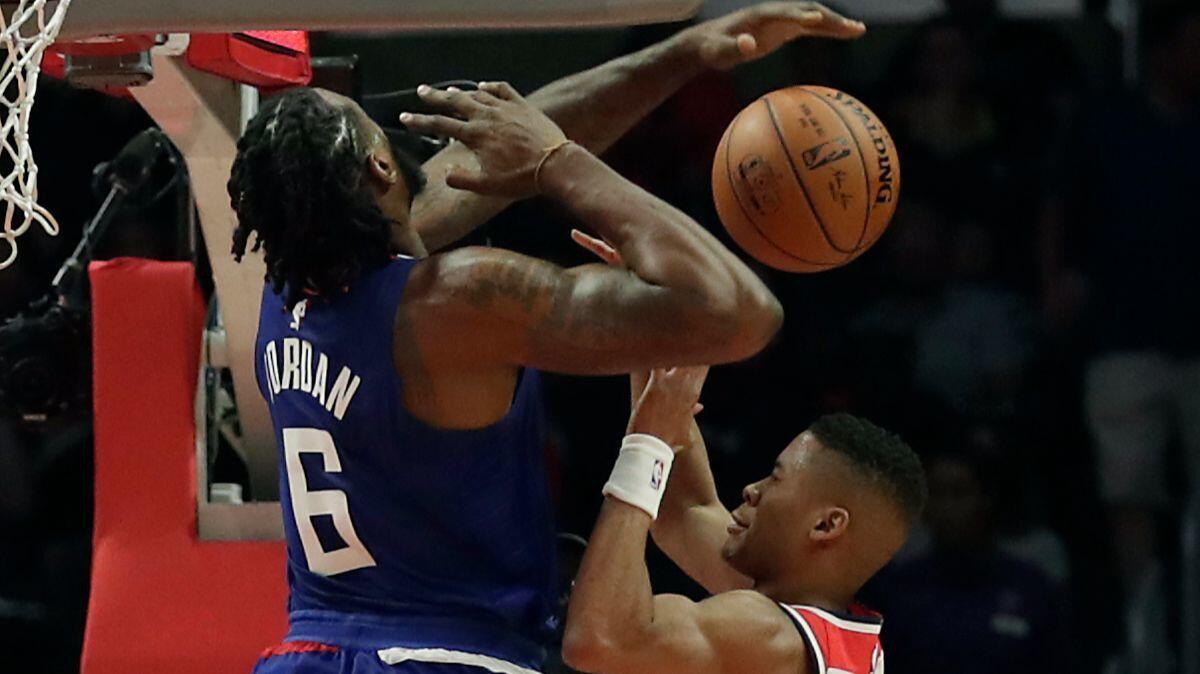Cllippers center DeAndre Jordan (6) blocks the shot of Wizards guard Tim Frazier during the second quarter at Staples Center on Saturday.