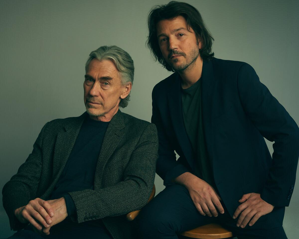 Showrunner Tony Gilroy and actor Diego Luna sit together wearing dark clothing for a portrait.
