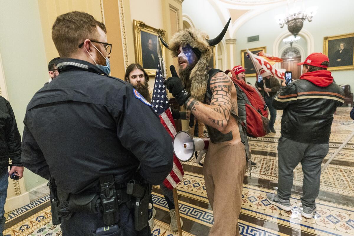 Supporters of President Trump are confronted by U.S. Capitol Police officers outside the Senate Chamber.