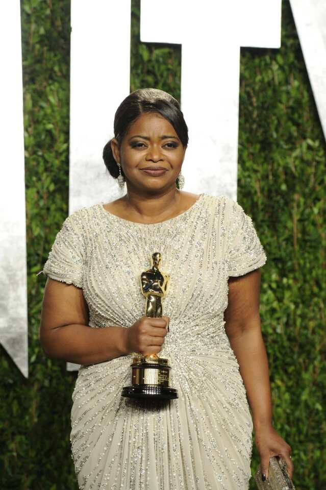 Octavia Spencer shows off her supporting actress Oscar for her role in "The Help" at the Vanity Fair party.