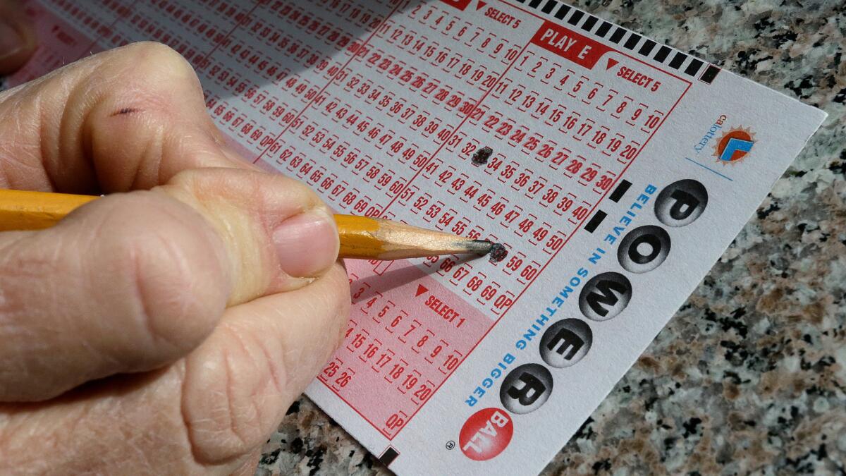 In this Jan. 12, 2016 file photo, a lottery player fills out numbers on a powerball form in Oakland.