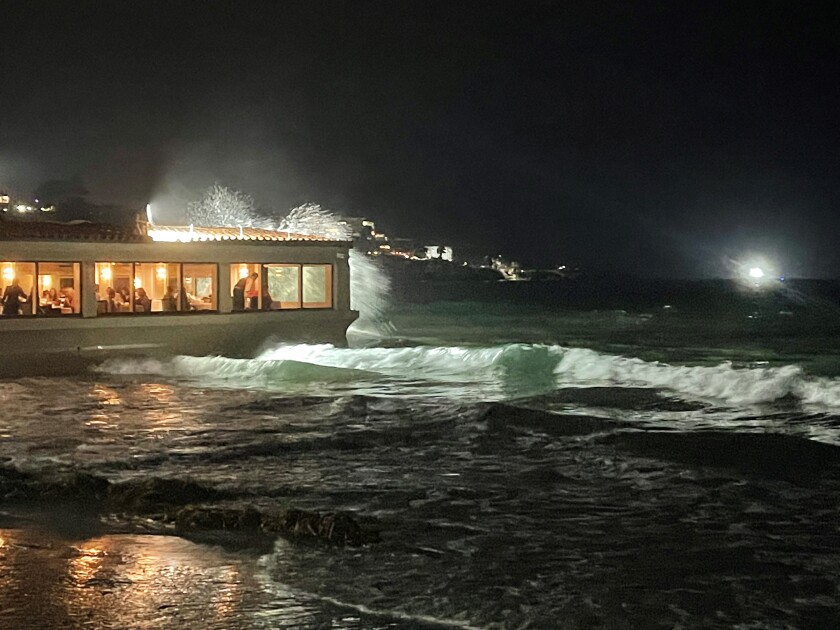 High-tide waves crash on the dining room windows of The Marine Room on La Jolla Shores beach.