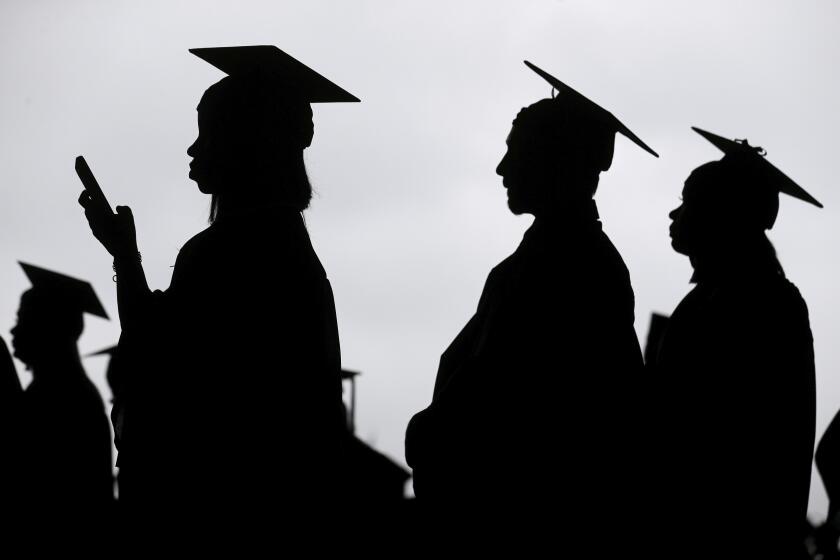 FILE - New graduates line up before the start of a community college commencement in East Rutherford, N.J., May 17, 2018. A federal judge in St. Louis on Thursday, Oct. 20, 2022, dismissed an effort by six Republican-led states to block the Biden administration's plan to forgive student loan debt for tens of millions of Americans. (AP Photo/Seth Wenig, File)
