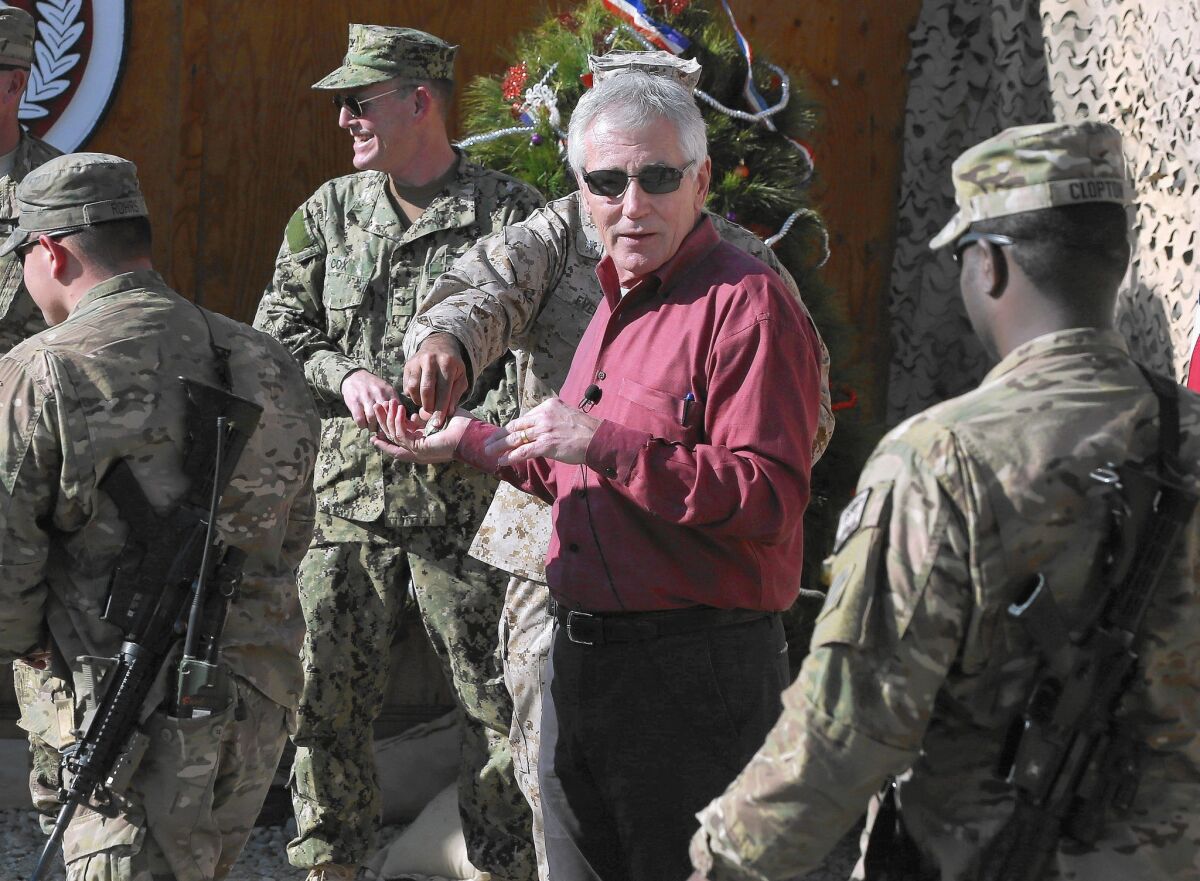 Defense Secretary Chuck Hagel speaks with U.S. troops at a base in Afghanistan's Laghman province during what has turned out to be his farewell tour.