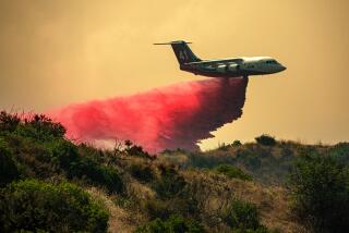 RIVERSIDE COUNTY, CA - JULY 15: An air tanker drops fire retardant as Rabbit Fire rages through Lamb Canyon threatening Beaumont on Saturday, July 15, 2023 in Riverside County, CA. (Irfan Khan / Los Angeles Times)