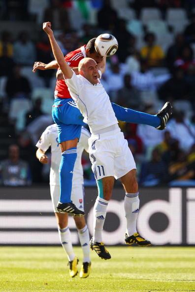 Robert Vittek of Slovakia is pushed by Carlos Bonet of Paraguay as they jump for the ball during the 2010 FIFA World Cup South Africa Group F match between Slovakia and Paraguay at the Free State Stadium on June 20, 2010 in Mangaung/Bloemfontein, South Africa.