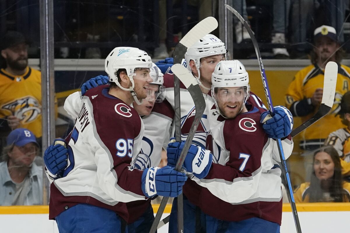 Colorado Avalanche players celebrate after a goal by Valeri Nichushkin (13) during the third period in Game 4 of an NHL hockey first-round playoff series against the Nashville Predators Monday, May 9, 2022, in Nashville, Tenn. The Avalanche won 5-3 to sweep the series 4-0. (AP Photo/Mark Humphrey)