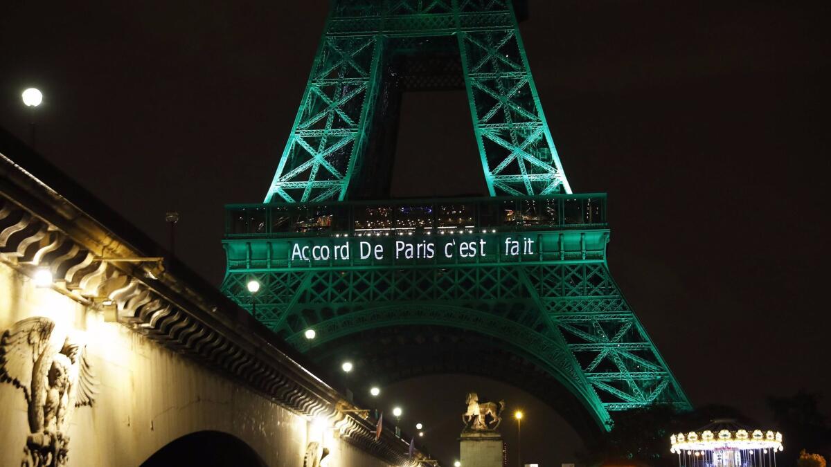 The Eiffel Tower is illuminated with the words "The Paris accord is done" on Nov. 4, 2016.