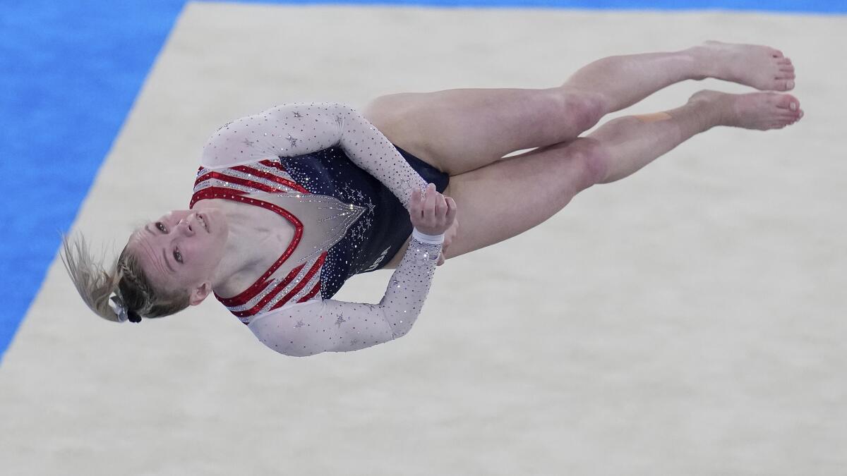 Jade Carey is shown midair above floor exercise mat.