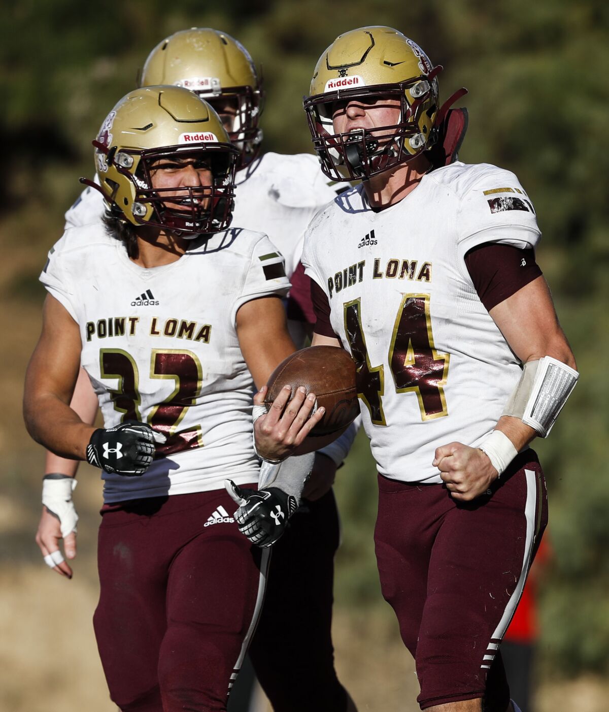Point Loma's Rocket Robinson (left) and Chase Lowary celebrate a touchdown against University City.