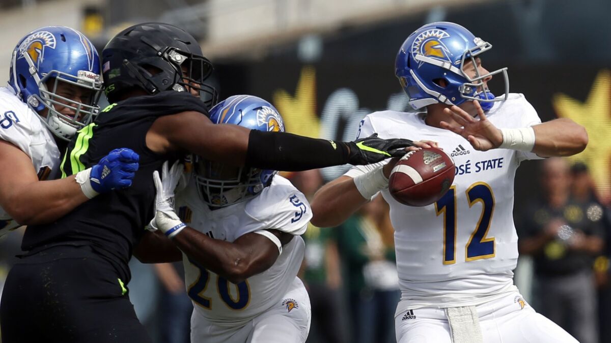 Oregon linebacker Justin Hollins nearly gets a hand on the ball as San Jose State quarterback Josh Love prepares to the throw during the first quarter of their game earlier this season.