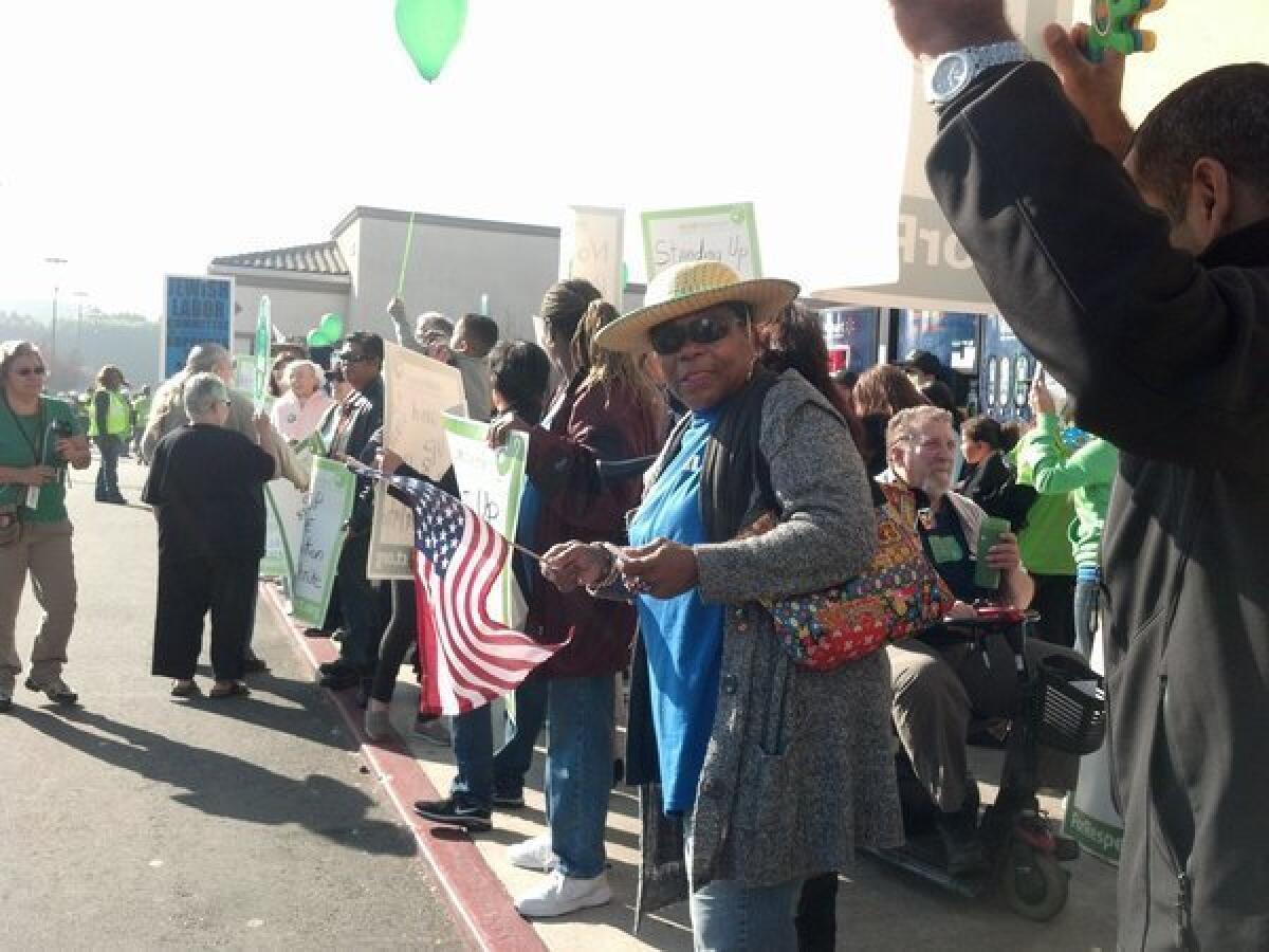 About 400 people protest outside a Wal-Mart in Paramount, Calif., agitating for better working conditions. Nine were arrested on suspicion of illegally assembling.