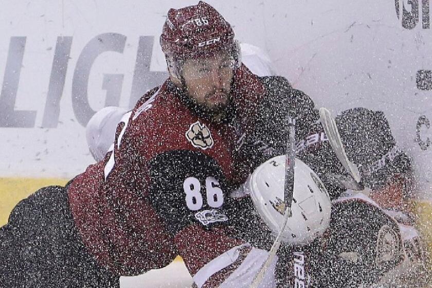 Coyotes right wing Josh Jooris (86) knocks Ducks defenseman Kevin Bieksa to the ice while battling for the puck in the second period on Feb. 20.