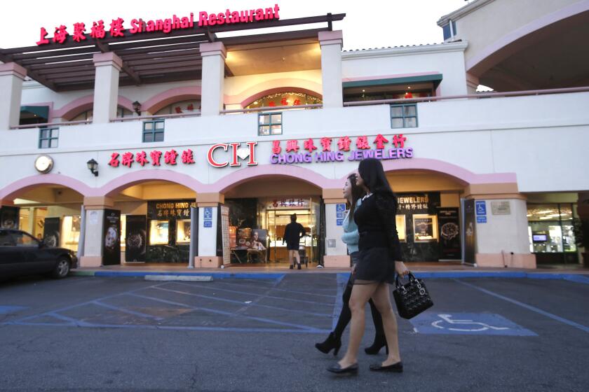 Shoppers walk through the San Gabriel Square in San Gabriel, where tourism from China is transforming the area.